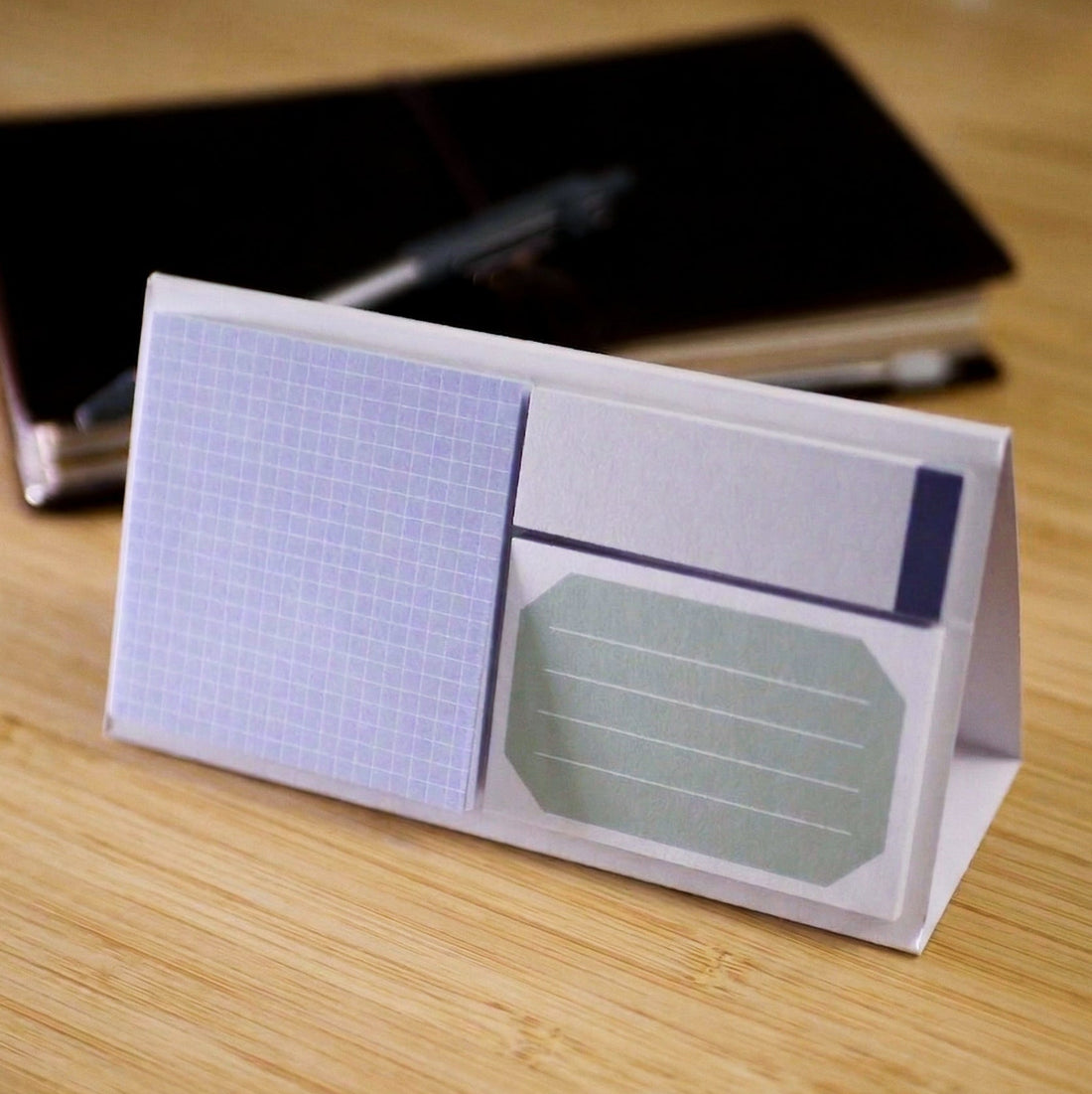 Sticky notes on a paper stand on a wooden surface
