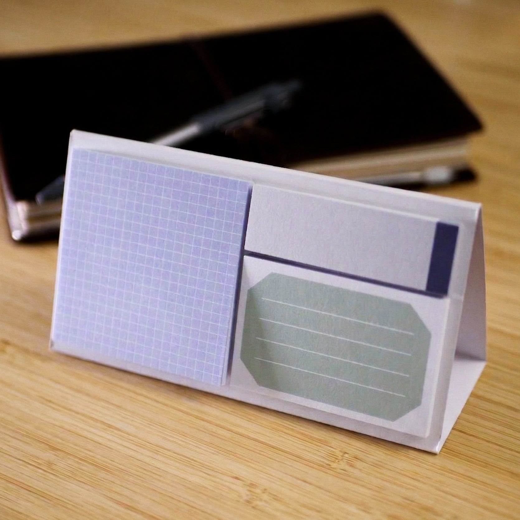 Sticky notes on a paper stand on a wooden surface