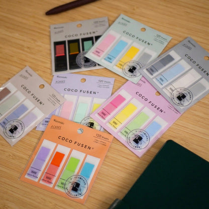 Various Coco Fusen Sticky Notes on top of a bamboo counter top